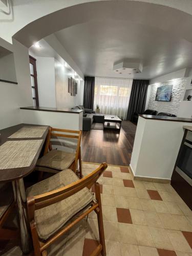 a living room with a table and chairs at Timi Residence in Braşov