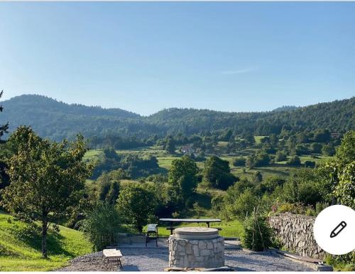 a picnic table with a view of a valley at Spacious apartment in nature with sauna! in Postojna