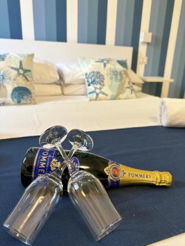 a bottle of wine sitting on top of a bed at Casa Onofrio Tropea in Tropea