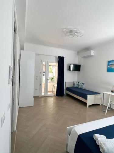 a living room with a bed and a tv at Casa Onofrio Tropea in Tropea