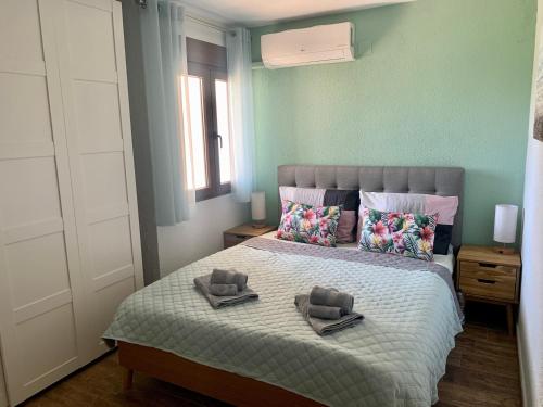 a bedroom with a bed with two towels on it at Apartment Flamenca , Orihuela Costa in Orihuela