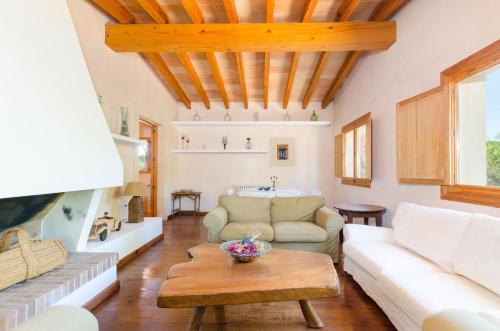 a living room with a couch and a table at YourHouse Son Jaumell in Capdepera