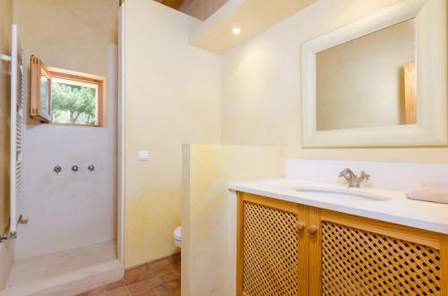 a bathroom with a sink and a shower and a mirror at YourHouse Son Jaumell in Capdepera