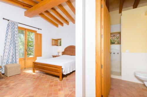 a bedroom with a bed and a bathroom at YourHouse Son Jaumell in Capdepera