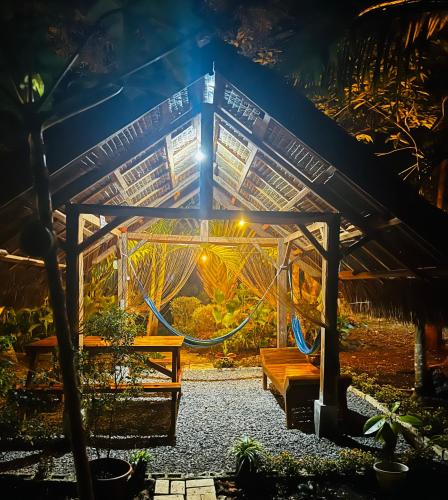 a greenhouse with a bench in a garden at night at Bohol Island Homestay in Dauis