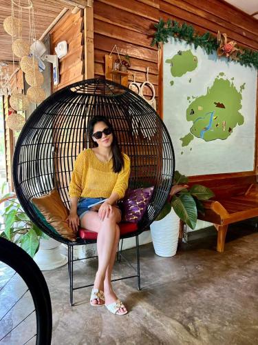 a woman sitting in a wicker chair at Bohol Island Homestay in Dauis
