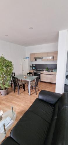 a living room with a couch and a table at Apartman MURKO P-2 in Brest