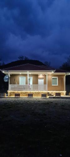a house with a porch with lights on it at OAZA in Mokra Gora