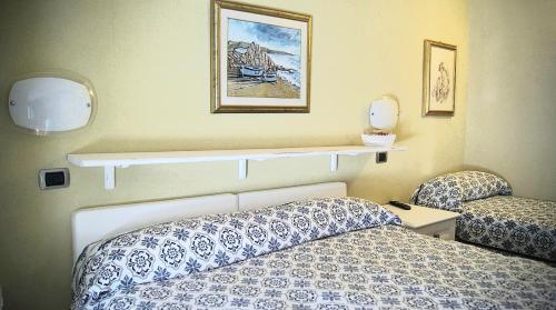 a hotel room with a bed and a shelf on the wall at affittacamere la loggia in Levanto