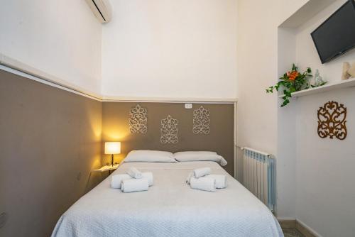 a bedroom with a large white bed with towels on it at Villa Giannina B&B in Taormina