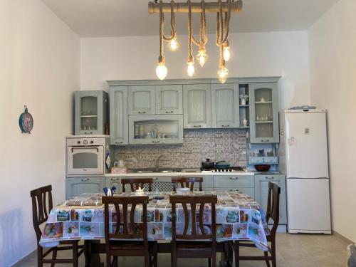 a kitchen with a table with chairs and a refrigerator at Il Casale Di Kevin in Monopoli