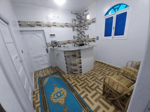 a bathroom with a sink and a counter in a room at Kayan Guest House in Aswan