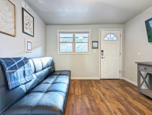 a living room with a couch and a window at The Fountain Creek Inn of Manitou Springs in Manitou Springs