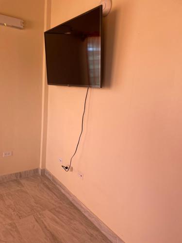 a flat screen tv hanging on a wall at Poinciana Apartments - Holiday Rental in Woods