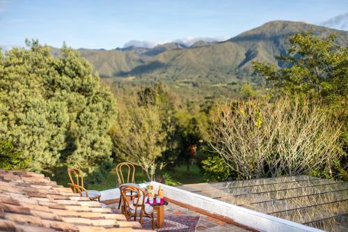 a table and chairs sitting on top of some stairs at PASSADHI Ayurveda & Yoga Retreat in Villa de Leyva