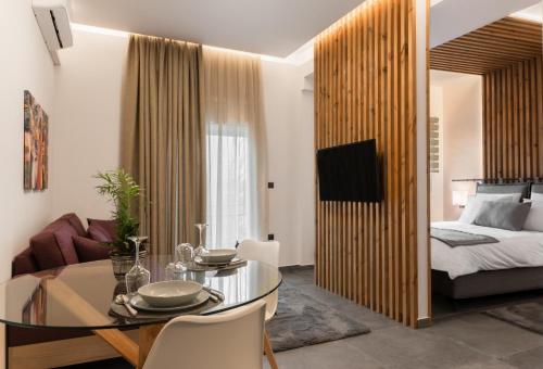 a living room with a bed and a glass table at DK APARTMENTS in Ioannina