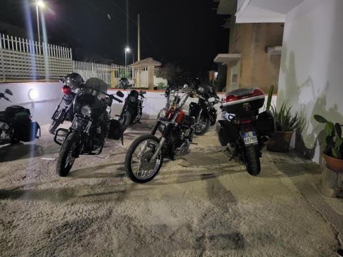 a row of motorcycles parked in a parking lot at night at Casa Villaggio Pirandello in Agrigento