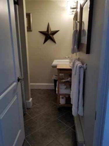 a bathroom with a sink and a star on the wall at Riverside with balcony Sheepscot Harbour Vacation Club Studio #215 in Edgecomb