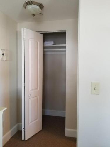 an empty room with a door and a closet at Riverside with balcony Sheepscot Harbour Vacation Club Studio #215 in Edgecomb