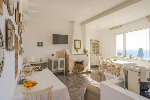 a living room with a table and a fireplace at Villa Giannina B&B in Taormina