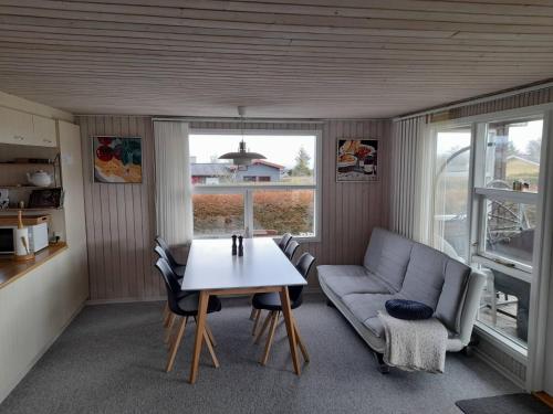 a living room with a table and a couch at Øster Hurup in Hadsund
