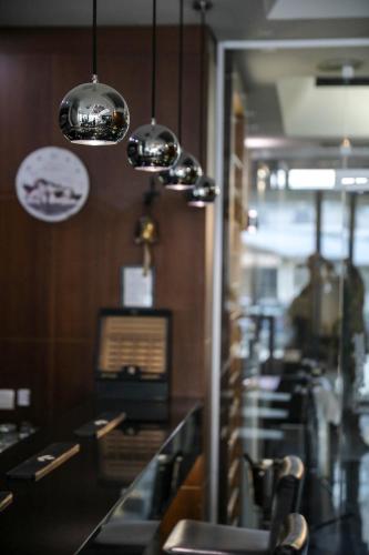 a restaurant with tables and chairs and lights at Hotel Dolce International in Skopje