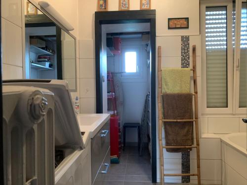 a bathroom with a sink and a mirror at Au kouglof avec Netflix in Colmar