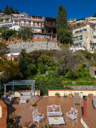 a group of chairs and tables on a patio at Villa Giannina B&B in Taormina