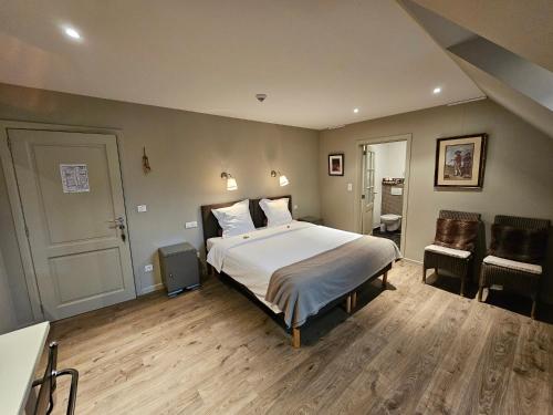 a bedroom with a large white bed in a room at Eyckenmolen B&B in Lierde