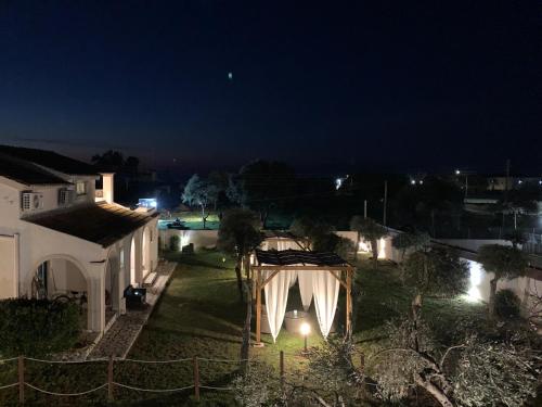 a view of a house at night with lights at Sirios in Acharavi