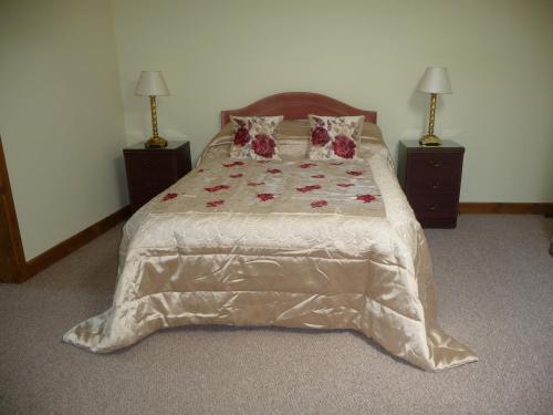 a bedroom with a large bed with flowers on it at Ivy Hall in Wootton Bridge