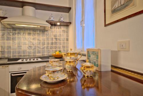 a kitchen with a table with four glass dishes on it at Casetta Mazzini in Rapallo