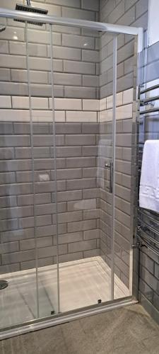 a shower with a glass door in a bathroom at Orchard House Hotel in Lynmouth