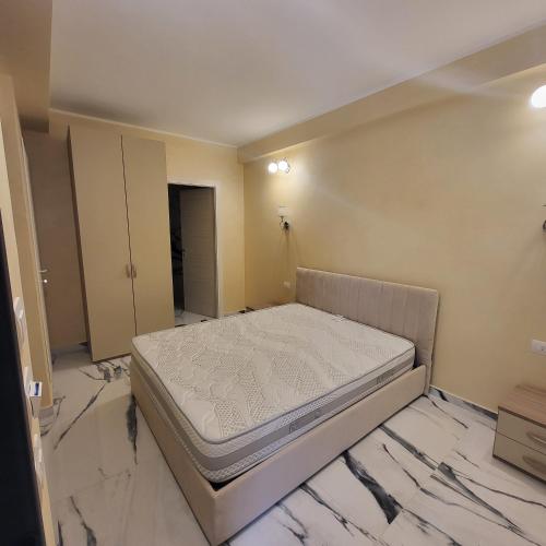 a bedroom with a bed in a room with marble floors at Residenza San Francesco in Zungri
