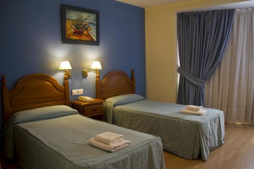 Postel nebo postele na pokoji v ubytování Hotel Clemente