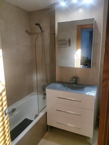 a bathroom with a sink and a shower and a tub at Casa Muir in Sucina