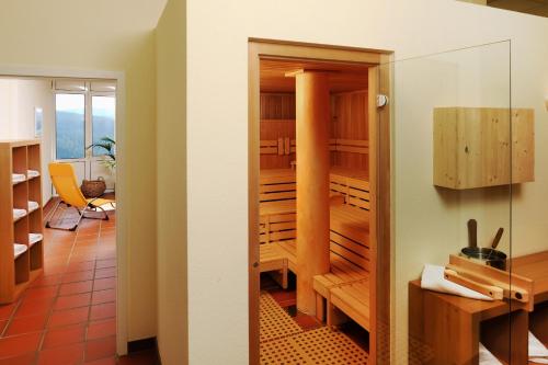 two views of a kitchen with a dining room at Haus Feldberg-Falkau in Feldberg