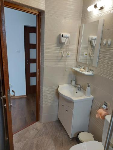 a bathroom with a sink and a toilet at CASA IV in Vama Veche