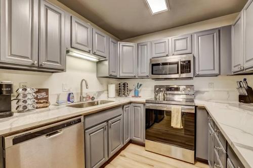 a kitchen with white cabinets and stainless steel appliances at Spacious Lakeview Heavenly Mountain Escape! in Stateline