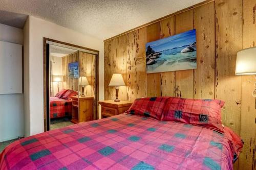 a bedroom with a bed and a mirror in it at Spacious Lakeview Heavenly Mountain Escape! in Stateline