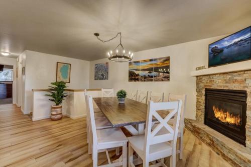 a dining room with a table and a fireplace at Spacious Lakeview Heavenly Mountain Escape! in Stateline
