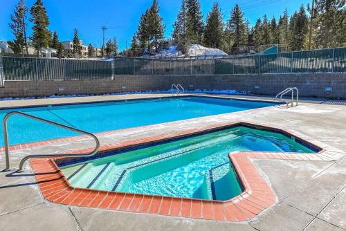 a swimming pool in a yard with a brick wall at Spacious Lakeview Heavenly Mountain Escape! in Stateline