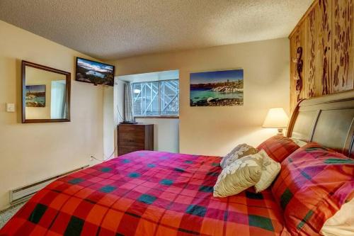 a bedroom with a bed with a colorful blanket at Spacious Lakeview Heavenly Mountain Escape! in Stateline