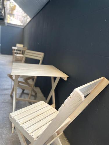 a table and a bench and a table and chairs at Hostel GARDEN St in Odesa
