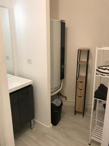 a room with a sink and a desk and a tv at Appartement numéro 4 ou numéro 8 in Savigné-lʼÉvêque
