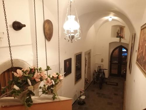 a hallway with a vase of flowers on a table at Apartman Deluxe Cheb in Cheb