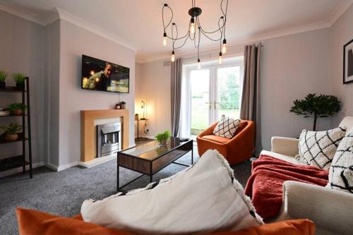 a living room with a couch and a table at Reduced rates for weekly, monthly and longer stays in Durham