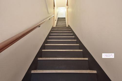 a staircase in a building with black and white walls at Casetta Mazzini in Rapallo
