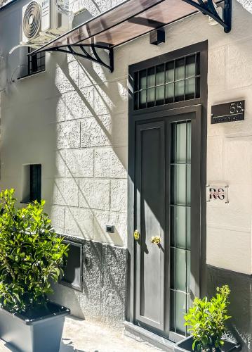 a black door on the side of a building at Rouge Suite & SPA PALERMO CENTRO in Palermo