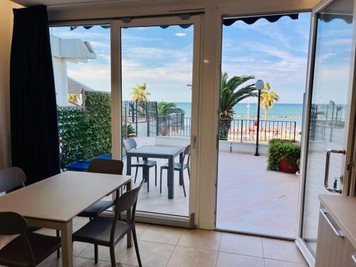 a dining room with a table and a view of the ocean at Residence Sei Delfini in Termoli